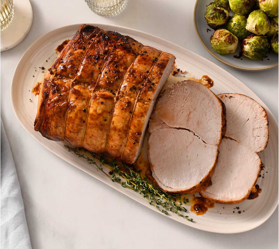 Sliced pork loin centre roast with brussel sprouts as a side