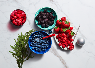 Bowls of fresh raspberries, strawberries and blueberries