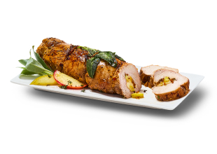 Pork tenderloin stuffed with apples and caramelized onions on a plate with two pieces cut off, sage leaves and apple slices